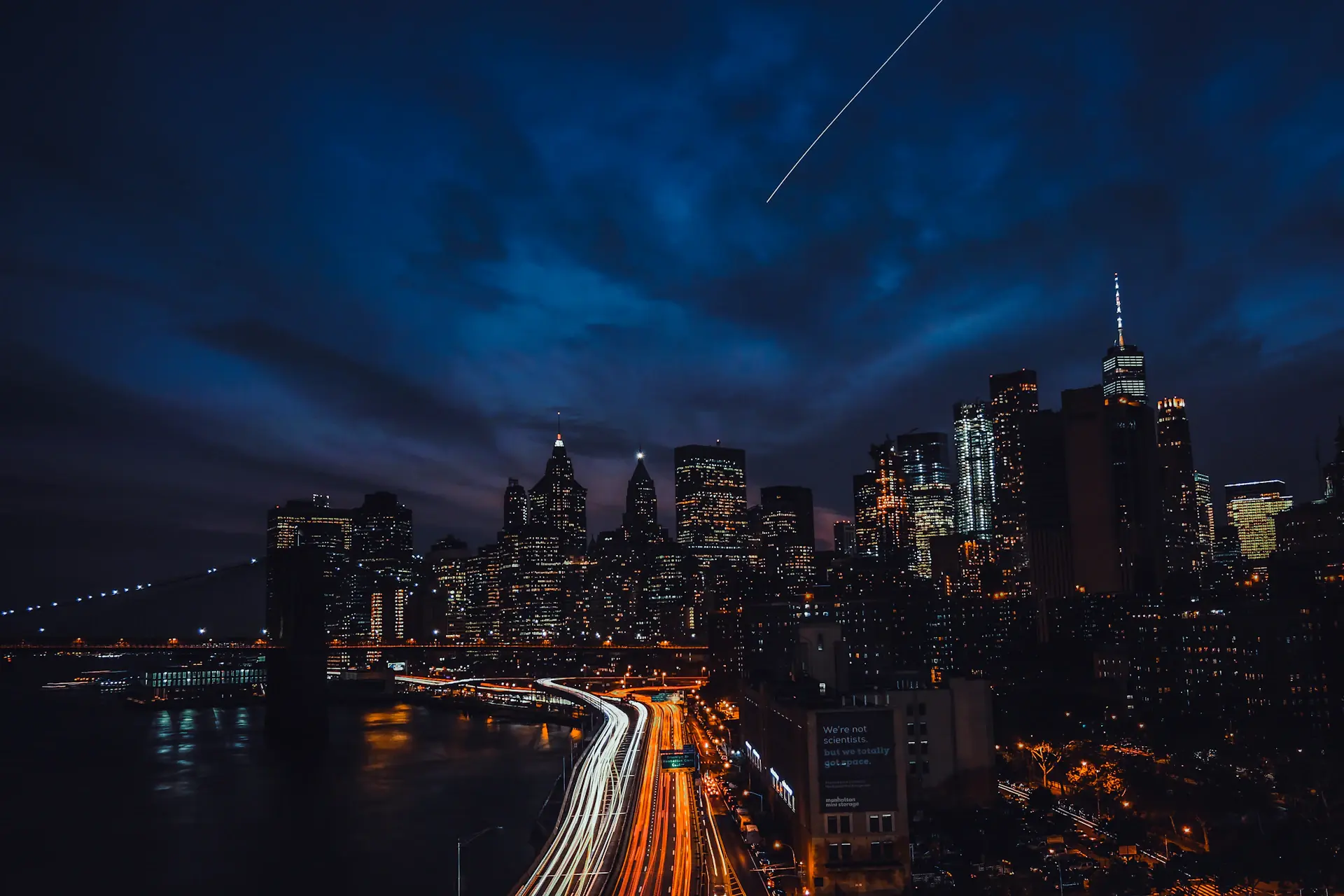 Manhattan skyline with light trails from traffic at night